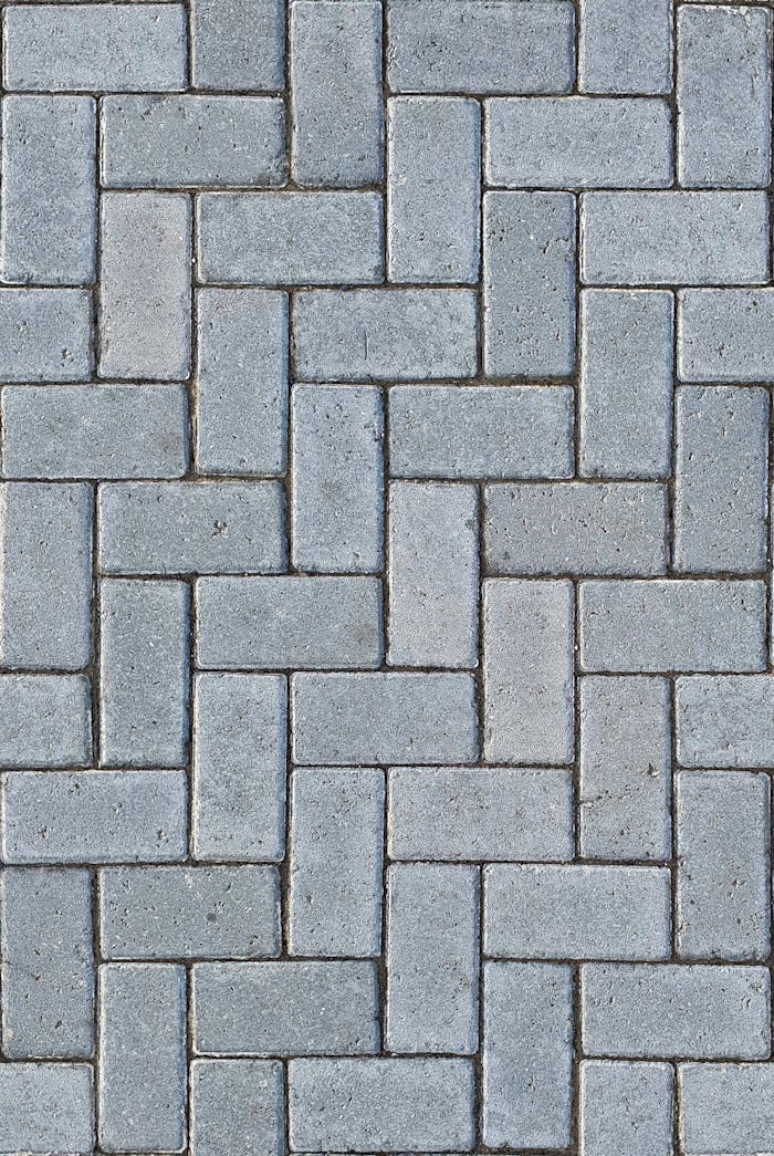 creative Detailed gray textured pavement with a classic herringbone pattern, ideal for design backgrounds.