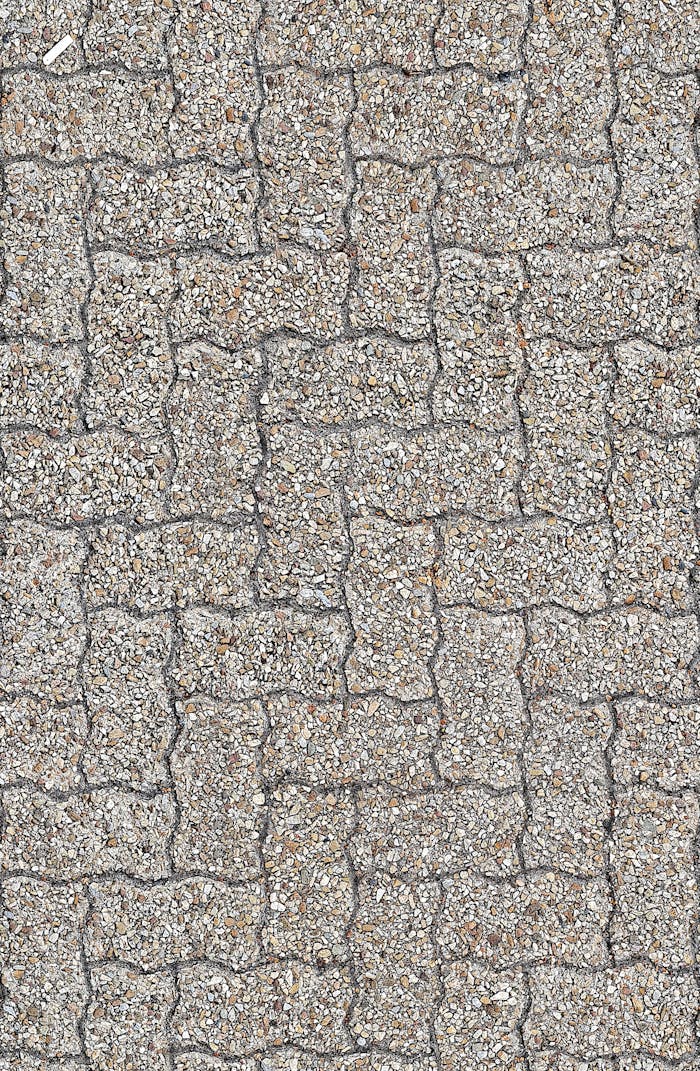 Services-01 High-resolution image of interlocking gray stone paver pattern from a vertical top view.
